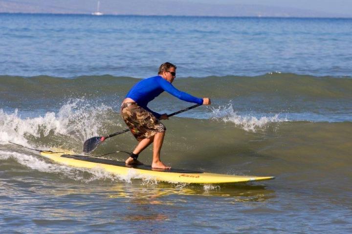 a young man riding a wave on a surfboard in the ocean